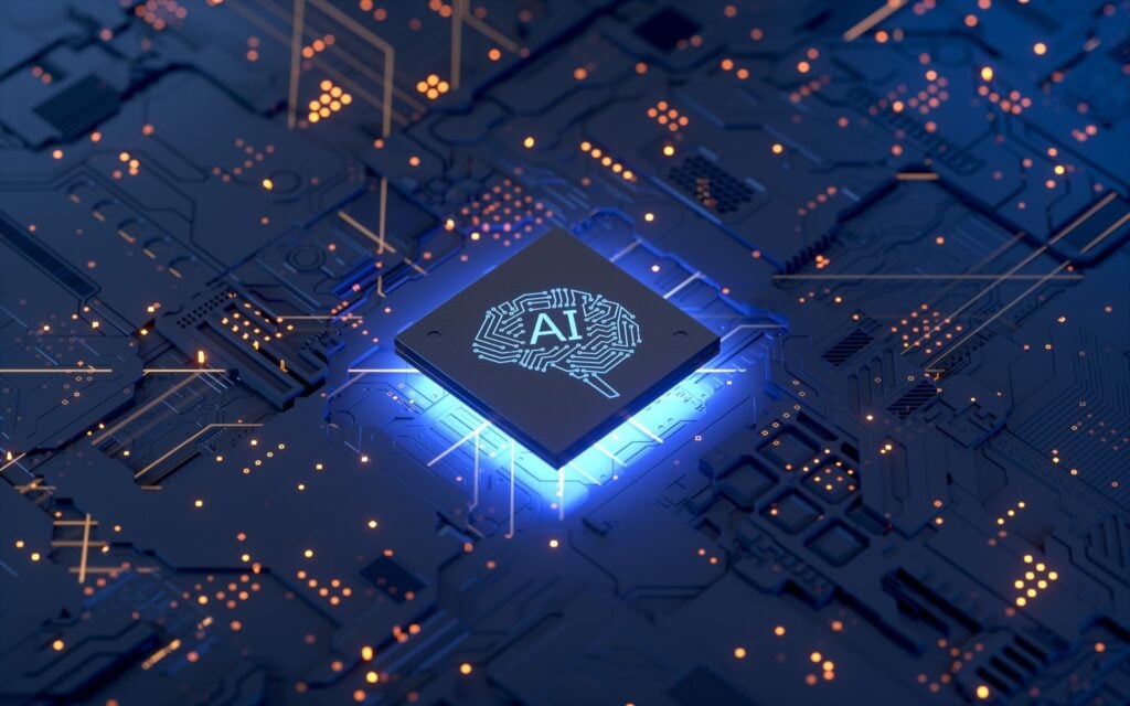 Computer chip (CPU) with AI written on it inside of a brain design