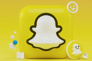 A 3D Snapchat ghost logo sits on a yellow square; it is surrounded by small, yellow, 3D icons